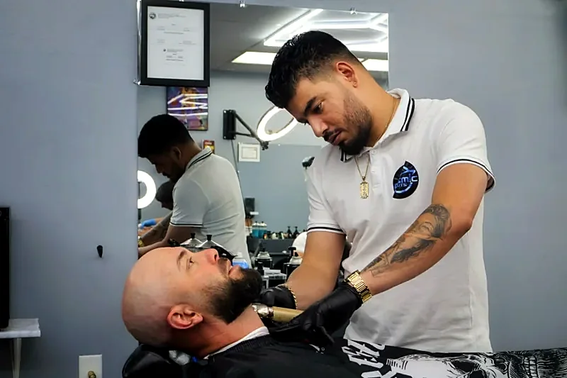 Barber trimming a beard