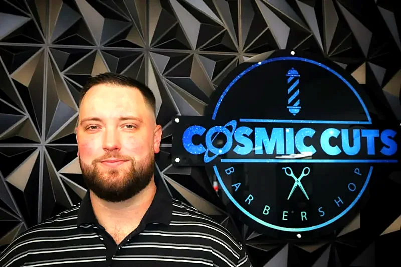 Client with beard in front of the logo