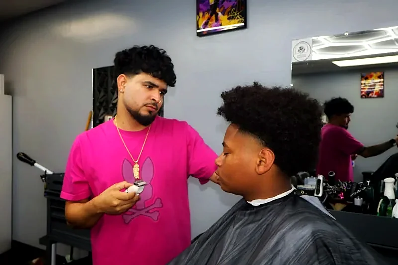 Barber working on curly hair
