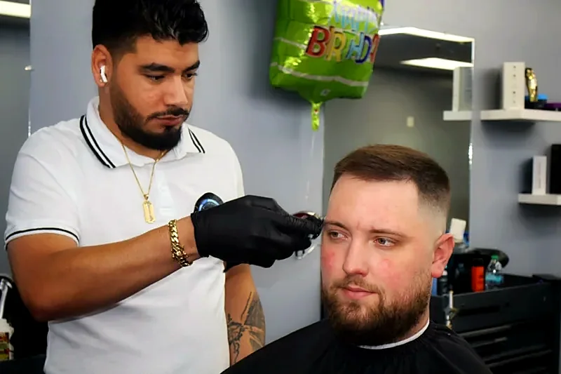 Barber detailing a fade